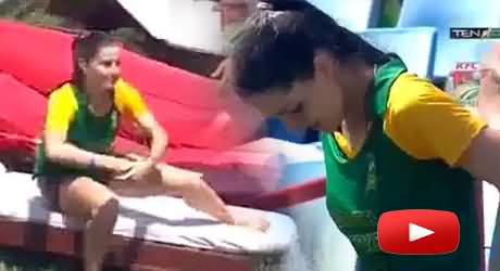 A Beautiful Girl in Green Shirt was Taking Sun Bath in The Stadium and Some One Threw Water on Her