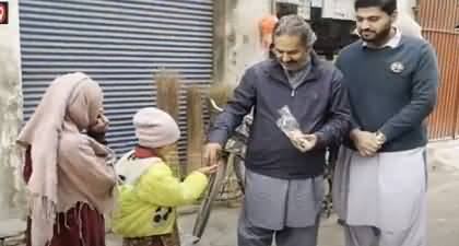 A candidate contesting election from Peshawar is distributing his electoral symbol 'Toys' in kids