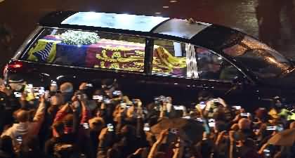 Crowds light phones as Queen Elizabeth's coffin arrives at Palace