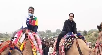 Fawad Chaudhry enjoying camel ride in protest against petrol price hike