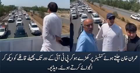 Imran Khan enjoying to see his caravan while standing on running container