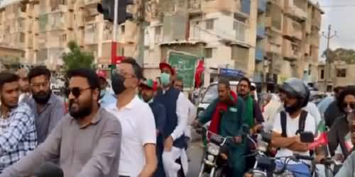 Law Abiding Minister Asad Umar Waiting for Green Traffic Signal While Travelling on Bike in Karachi