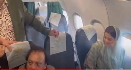 Maryam Nawaz giving autograph in plane to her fans