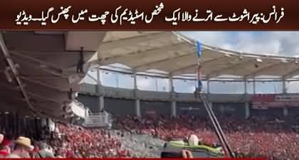 Moment parachutist rescued after dangling on rugby stadium roof