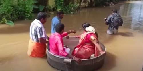 Necessity is The Mother of Invention - Indian Couple Float to Wedding in Cooking Pot After Floods in Kerala