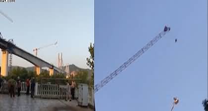Out of the frying pan into the fire, Paraglider got stuck on a crane in China’s Sichuan Province