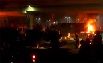 PTI workers set cloth container on fire at Kalma Chowk Lahore