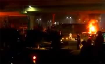 PTI workers set cloth container on fire at Kalma Chowk Lahore