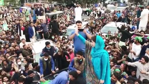 Such A Large Crowd Around Maryam's Car While She Is Waving Hands on Car's Roof