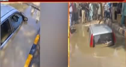 Torrential rain in Karachi causes road collapse, A car fell into the hole, women rescued from car